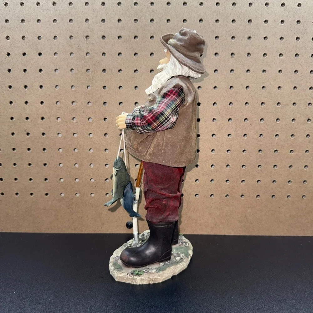 Christmas 2005 Santa fishing figurine holding a fishing pole and fish plastic